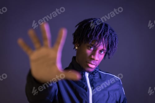 Preview: Black person doing the stop racism gesture on a black background