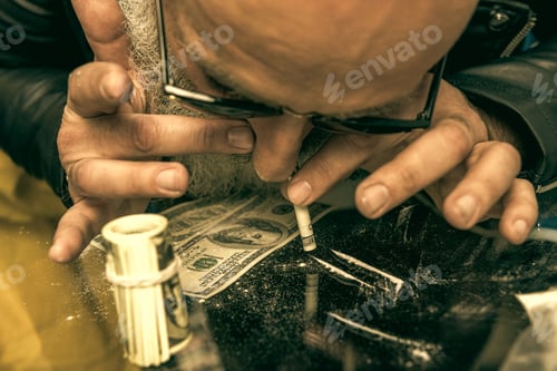 Preview: close up of grey hair man with beard taking drugs, drugs concept