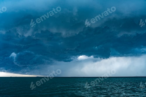 Preview: View of tropical ocean storm with menacing clouds and rain showering below