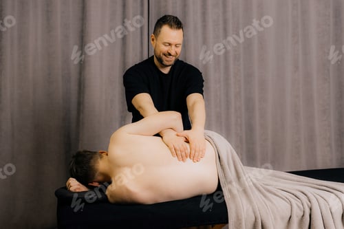 Preview: image of physiotherapist massaging man in hospital