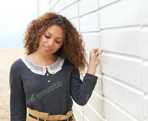 Preview: beautiful woman walking with hand on wall