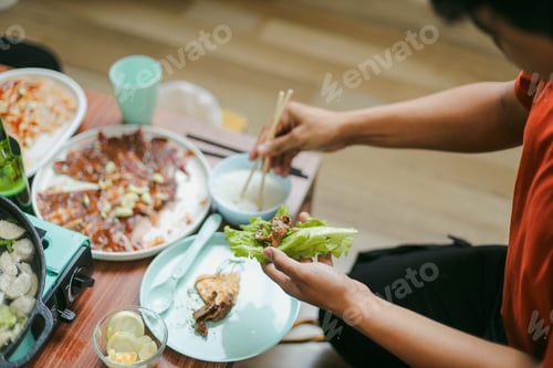 Preview: Close-up Hands Prepare To Eat Grilled Barbecue Beef with Vegetable Korean Style