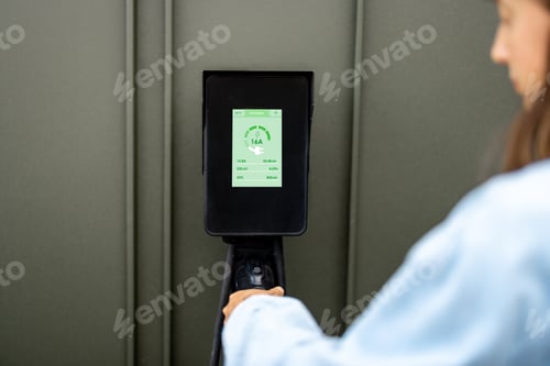 Preview: Woman takes a plug of a charging wall station