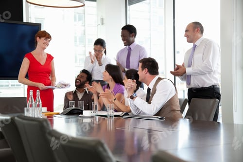 Preview: Colleagues listening to businesswoman