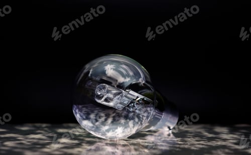 Preview: Intriguing light illuminating the light bulb in a dimly lit setting creating a mysterious aesthetic