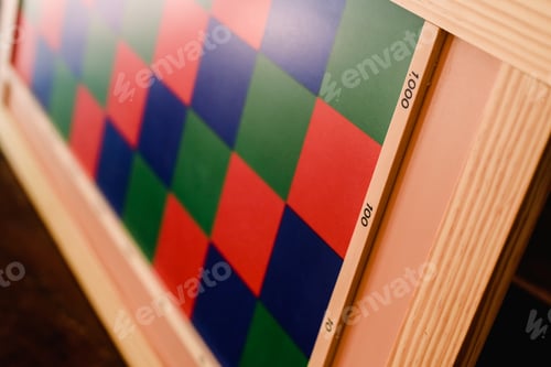 Preview: Game to learn to count, made of blue and red wood, inside a classroom montessori.