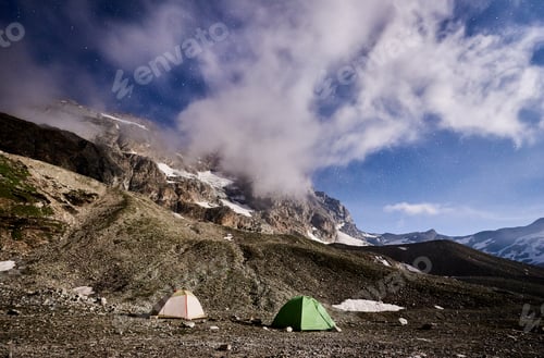 Preview: Matterhorn, Monte Cervino mountain with tourist tents at night.