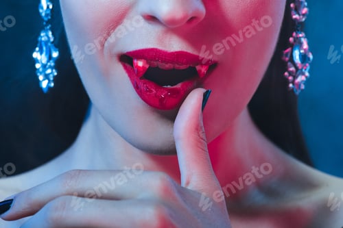 Preview: cropped view of vampire with bloody lips and fangs