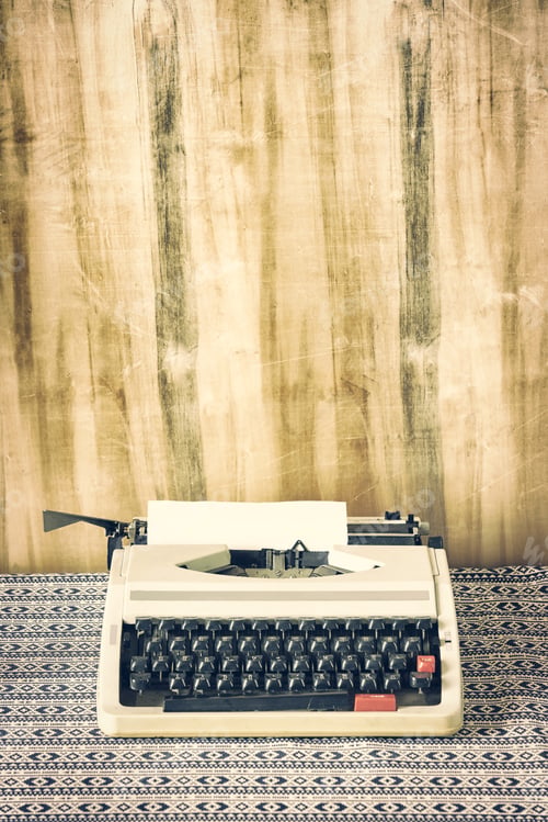 Preview: Old retro typewriter on table on wood background