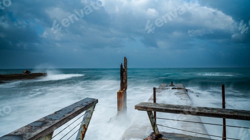 Preview: Wooden pier engulfed by the powerful force of high surf and crashing waves