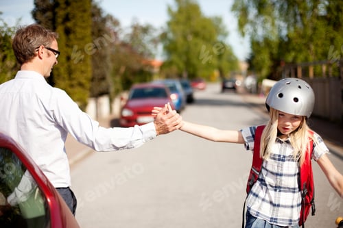 Preview: Father giving high-five to daughter on street