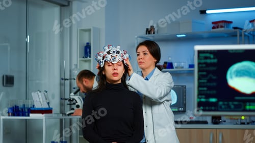 Preview: Asistance of neurological doctor putting eeg headset on patient head