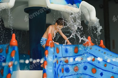 Preview: Boy having fun in aqua park