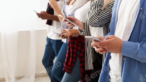 Preview: Group of Teenagers Standing Holding Cell Phones, Copy Space