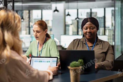Preview: Diverse office colleagues reviewing business insights on laptop