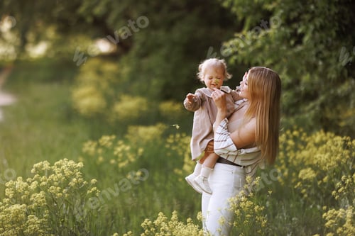 Preview: Young european woman in casual clothes with a small child