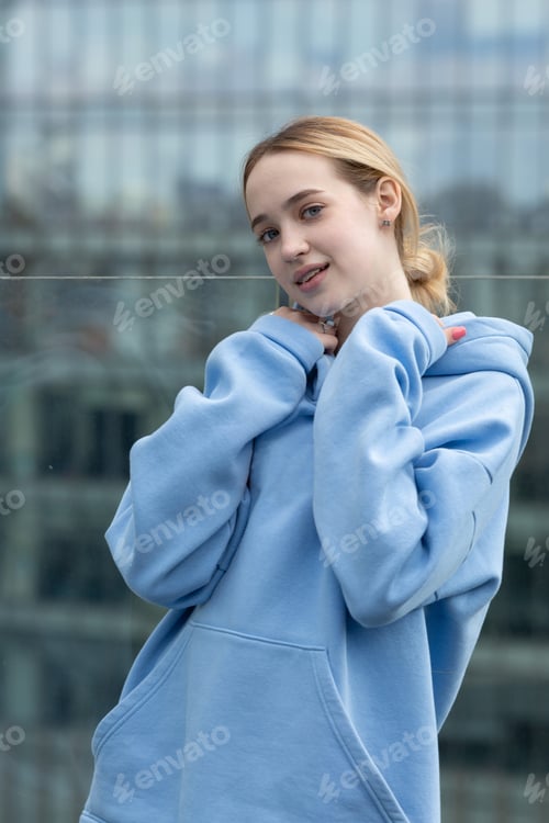 Preview: A teenage girl in a hoodie with braces on her teeth