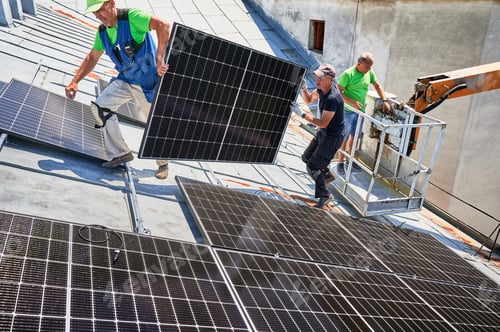 Preview: Workers building solar panel system on roof of house. Installers carrying photovoltaic solar module