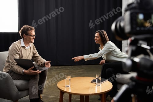 Preview: Engaging discussion between a journalist and a specialist in a modern interview setting