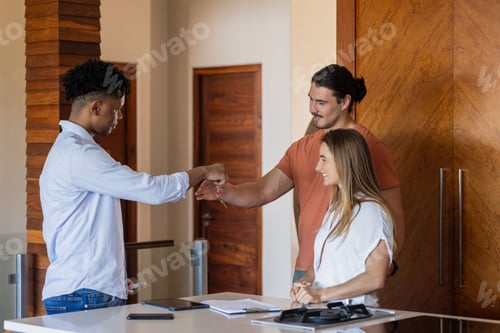 Preview: Diverse friends greeting with fist bump in modern office, smiling and connecting