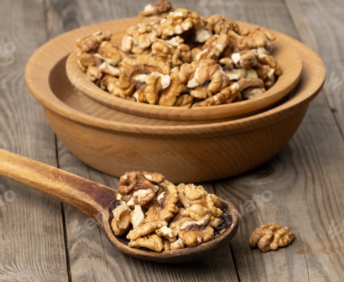 Preview: Peeled walnuts in a wooden plate on the table