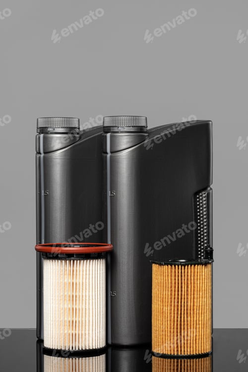 Preview: Car oil filters and motor oil can on dark background