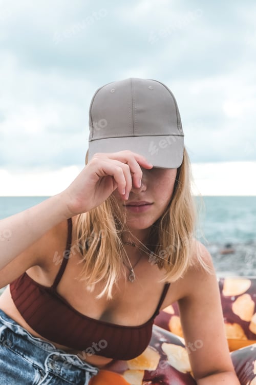 Preview: Traveler girl resting on the beach near the sea. Eco travel, taking care of yourself physical and