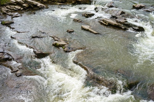 Preview: Texture Of Rapid River With Fresh Cold Water Flowing Through Mountain Rocks With Foam And Bubbles