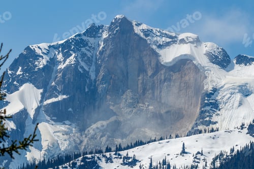 Preview: Snow-covered mountain under a bright blue sky