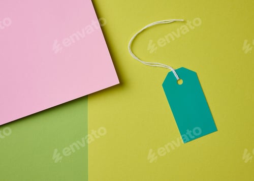 Preview: Blank pink cardboard tag on white rope, green background
