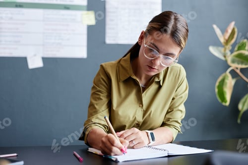 Preview: Woman Writing in Notebook during Test in Class while Studying English Language