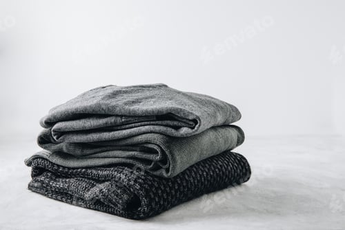 Preview: Sweaters. Black knitted sweaters on gray background.