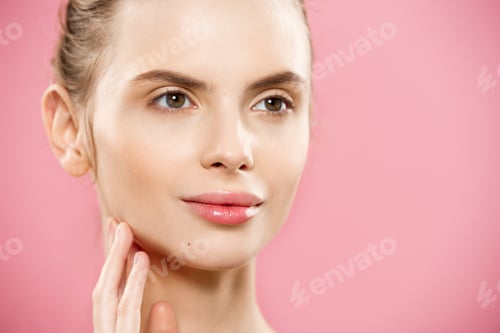 Preview: Beauty Concept - Beautiful Woman with Clean Fresh Skin close up on pink studio. Skin care face
