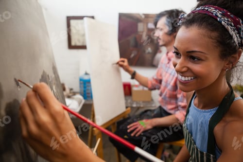 Preview: Man and woman painting on canvas