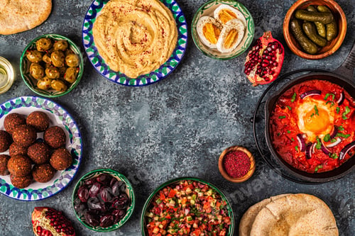 Preview: Falafel, hummus, shakshuka, Israeli salad - traditional dishes of Israeli cuisine.