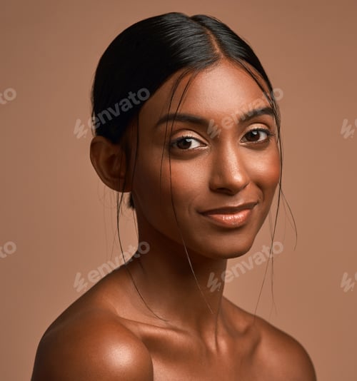 Preview: Portrait of a beautiful young woman posing against a brown background
