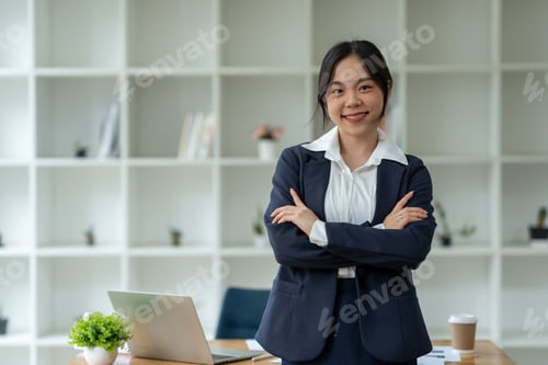 Preview: Asian businesswoman standing working with laptop computer, mobile phone, tablet to contact, chat, se