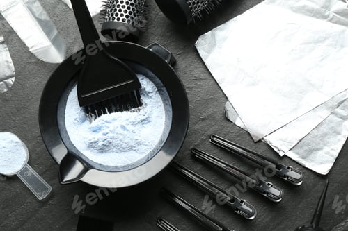 Preview: Bleaching powder and hairdresser's tools on black table, flat lay