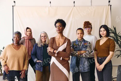 Preview: International Women's Day portrait of cheerful multi ethnic mixed age range women laughing