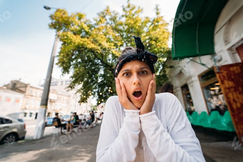 Preview: girl is emotional and amazed on terrace outdoor