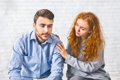 Preview: Woman comforting depressed man at rehab group meeting
