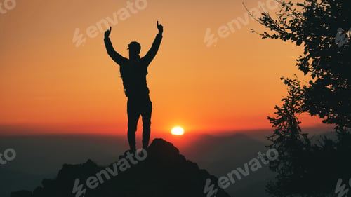 Preview: Man in silhouette in front of idyllic sunset in the hills
