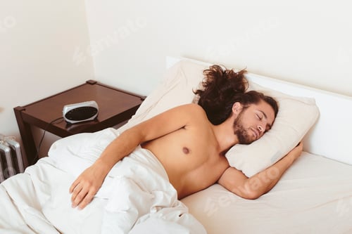 Preview: Young man asleep in bed