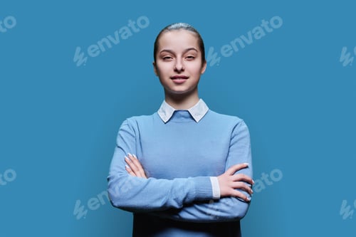 Preview: Portrait of smiling high school student girl on blue background