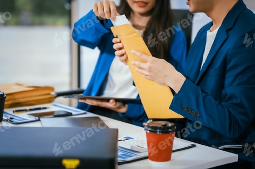 Preview: A male and female lawyer are sitting at a desk in an office, discussing legal documents offering