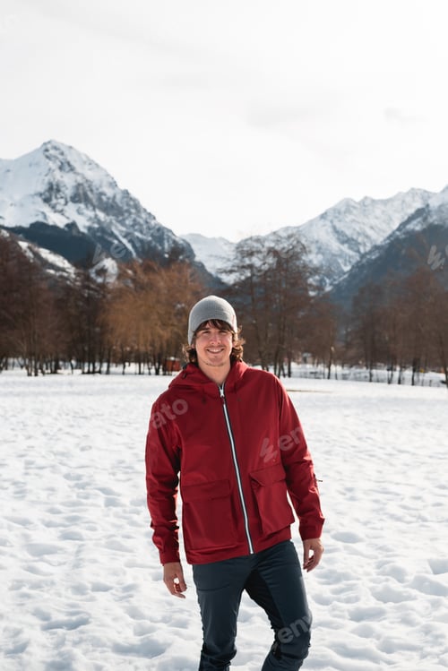 Preview: Man Smiling in Red Jacket in Pyrenees Winter Landscape