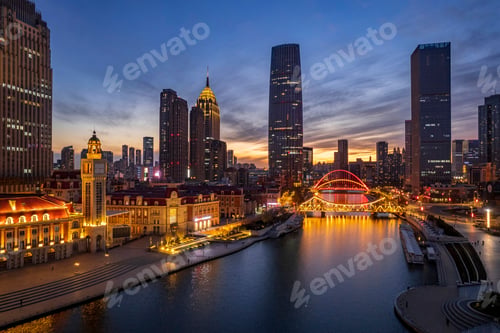 Preview: Aerial shot of an urban skyline with landmarks along the Haihe River in Tianjin, China at sunset