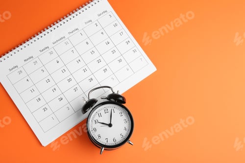 Preview: Calendar and alarm clock on orange background, flat lay. Space for text