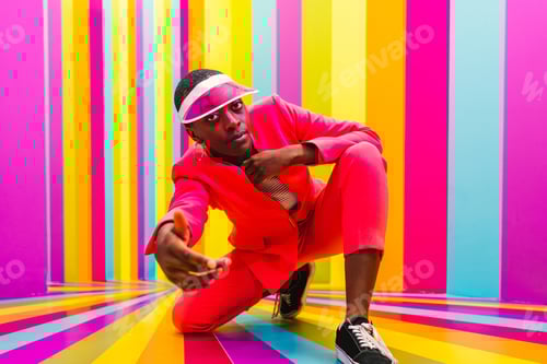 Preview: Beautiful young woman dancing and having fun inside a rainbow box room