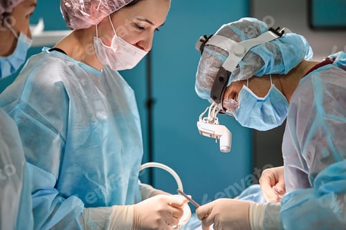 Preview: Surgical team in the operating room, close-up. An international team of professional doctors in a